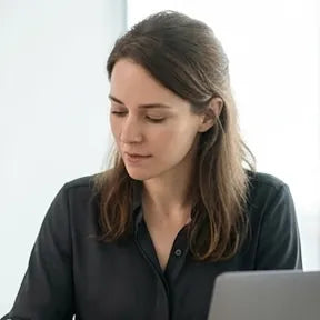 A woman focused on her work at her desk